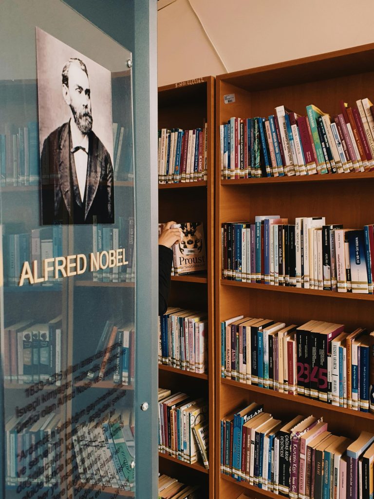 Books on Brown Wooden Shelf