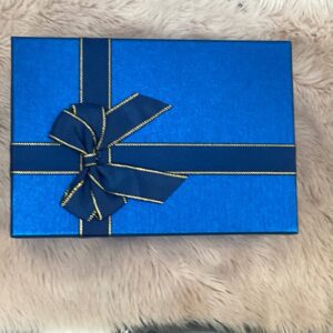 Caja de regalo pequeña azul elegante con lazo azul y detalles dorados