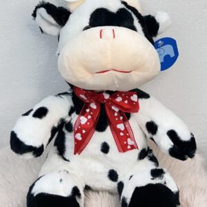 Peluche de vaca con lazo rojo