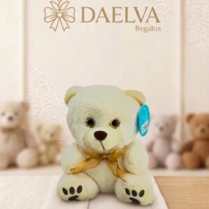 Peluche de osito con lazo amarillo, de pelo crema, hocico claro y almohadillas marrones